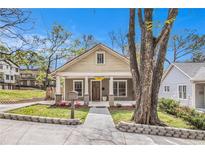 Charming home featuring a welcoming front porch and beautifully landscaped front yard under a clear, blue sky at 559 Robinson Se Ave, Atlanta, GA 30315