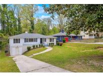 Charming one-story home featuring a well-maintained yard, driveway, and inviting curb appeal at 111 Leathers Circle Nw, Atlanta, GA 30314