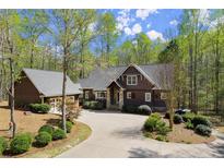Charming home with a well-manicured lawn, beautiful trees and a large driveway leading to the garage at 208 Greenhill Dr, Dallas, GA 30157