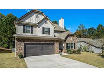 Charming two-story home featuring stone accents, a two-car garage and well-manicured landscaping at 353 Daffodil Dr, Temple, GA 30179