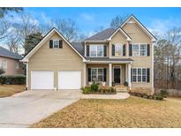 Charming two-story home featuring a two-car garage and well-maintained landscaping at 405 Ballymore Pass, Woodstock, GA 30189