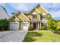 Charming two-story home featuring a well-manicured lawn, two-car garage, and inviting front porch at 4461 Kentland Dr, Acworth, GA 30101