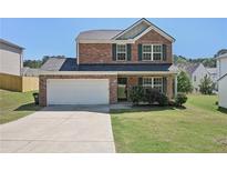 Charming two-story brick home with a well-maintained front yard and an attached two-car garage at 5675 Laurel Ridge Cir, Atlanta, GA 30344