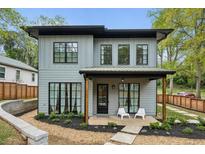 Charming two-story home boasts a modern design, covered front porch, and black frame windows at 1010 Violet Sw St # A, Atlanta, GA 30310