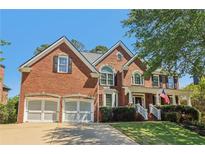 Beautiful brick two-story home with a well-manicured lawn and a two-car garage at 2130 Hollowbrooke Nw Way, Acworth, GA 30101