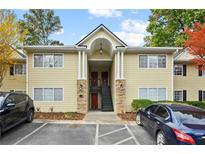 Charming two-story condo with inviting entrance, stone accents, and ample parking spaces at 1468 Briarwood Ne Rd # 810, Brookhaven, GA 30319