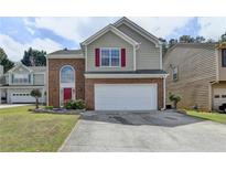 Charming two-story home featuring a brick facade, red shutters, and an attached two-car garage at 2274 Stancrest Ln, Lawrenceville, GA 30044