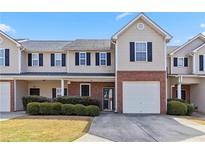 Charming townhome with brick accents, tidy landscaping, and a convenient attached garage at 69 Eagle Glen Dr, Cartersville, GA 30121