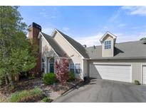 Charming home featuring a well-maintained lawn and a two-car garage with an inviting facade at 1478 Settlers Walk Sw Way, Marietta, GA 30060