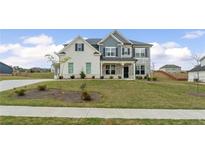Charming two-story home featuring a combination of painted brick and stone facade with a well-manicured lawn at 133 Bastian Rd, Mcdonough, GA 30252