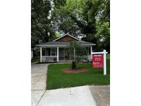 Charming single-story home with a welcoming front porch and well-maintained lawn at 305 Henry Aaron Sw Ave, Atlanta, GA 30310