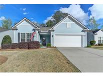 Charming, light blue single-story home featuring a two-car garage and well-maintained front yard at 4230 Braden Nw Ln, Kennesaw, GA 30144
