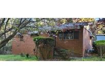 Charming brick home exterior with blossoming tree in the front yard at 102 Welch St, Stockbridge, GA 30281