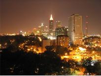 Striking cityscape view at night, featuring illuminated buildings and lush trees at 1101 Juniper Ne St # 1511, Atlanta, GA 30309