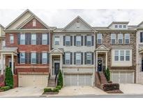Charming townhomes featuring brick and stone facades, garage parking, and welcoming front entrances at 4836 Se Merriman Se Walk # 23, Smyrna, GA 30080