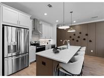 Modern kitchen featuring stainless steel appliances, a large island, and pendant lighting at 538 Sawnee Village Blvd # D67, Cumming, GA 30040