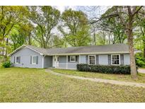 Charming single-story home with light-blue siding, a white front porch, and a well-maintained front yard at 806 Jefferson Sw Ct, Conyers, GA 30094