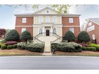 Stately brick home featuring manicured landscaping, grand staircase, and classic architectural details at 3022 Loridan Se Way, Atlanta, GA 30339