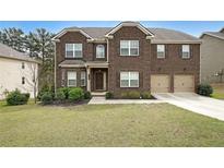 Beautiful two-story brick home with a well-manicured lawn and attached two-car garage at 3725 Rifflewood Way, Douglasville, GA 30135