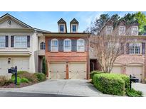 Charming brick townhome with a two-car garage and meticulously maintained landscaping at 4428 Wilkerson Manor Se Dr # 6, Smyrna, GA 30080