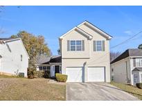 Charming two-story home with a two-car garage and well-maintained front yard at 6422 Phillips Ct, Lithonia, GA 30058