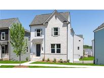 Charming two-story home featuring a painted brick facade, symmetrical windows, and a welcoming front entrance and manicured lawn at 2721 Creek View Nw Ter, Atlanta, GA 30318