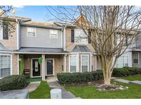 Charming townhome with brick and vinyl siding, covered entrance, and manicured lawn at 109 Odyssey, Conyers, GA 30012