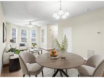Bright living room featuring an abundance of natural light and a cozy dining space with modern accents at 109 Odyssey, Conyers, GA 30012