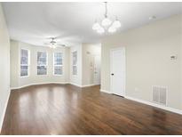 Bright living room with hardwood floors, bay windows, and modern lighting fixtures at 109 Odyssey, Conyers, GA 30012