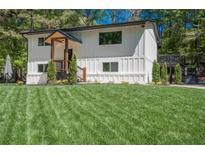 Charming two-story home with a manicured lawn and modern, farmhouse-style architecture at 418 Robinson Rd, Peachtree City, GA 30269