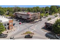 Aerial view of a historic building on a street corner with crosswalks and other buildings nearby at 1133 Church St # 1, Covington, GA 30014