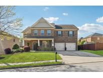 Charming two-story brick home with a well-manicured lawn and a two-car garage at 368 Sawyer Meadow Way, Grayson, GA 30017