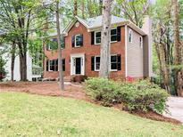 Charming brick two-story home with black shutters and a well-manicured lawn at 2863 Landing Dr, Marietta, GA 30066