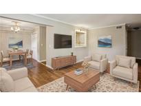 Inviting living room featuring hardwood floors, a neutral color palette, and comfortable seating arrangement at 3091 Colonial Way # F2, Atlanta, GA 30341
