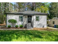 Charming single-story home with updated siding, landscaping, and a welcoming front entrance at 437 Collier Ridge Nw Dr, Atlanta, GA 30318