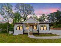 Charming single-Gathering home with a manicured lawn and inviting entrance at 5469 Helen Pl Sw, Mableton, GA 30126