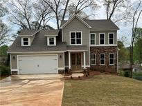 Charming two-story home featuring stone accents, a spacious garage, and a well-manicured front yard at 71 Dillard Ne Dr, Kennesaw, GA 30144