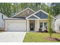 Charming single-story home with brick and stone accents, complemented by a well-manicured lawn and a two-car garage at 3953 Brushy St, Powder Springs, GA 30127