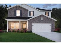 Charming two-story home features a brick facade, covered porch, and attached two-car garage at 3961 Brushy St, Powder Springs, GA 30127