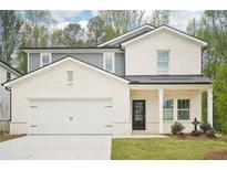 Charming two-story home with a covered front porch and attached two-car garage at 3961 Brushy St, Powder Springs, GA 30127