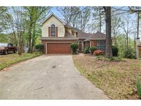 Charming home with a brick and siding exterior, a two-car garage, and a well-maintained front yard at , Stone Mountain, GA 30088