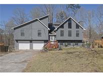 Charming two-story home with two-car garage and mature trees in a desirable neighborhood at 525 Penny Ln, Woodstock, GA 30188