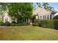 Charming single-story home with manicured lawn, mature landscaping, and inviting front entrance at 5628 Harbormist Dr, Powder Springs, GA 30127