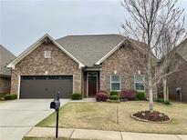 Charming brick home with well-manicured lawn and two-car garage at 725 Valley Glen Dr, Dacula, GA 30019