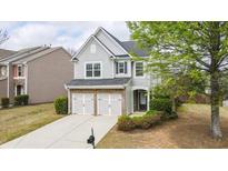 Charming two-story home with a well-maintained lawn, brick accents, and a two-car garage at 5510 Weddington Dr, Cumming, GA 30040