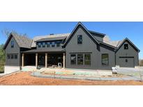 New construction exterior elevation showing board and batten siding and dark trim at 00 Pebble Rock Dr, Cumming, GA 30041