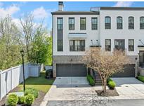 Elegant townhouse with painted brick, attached two-car garage, and manicured landscaping at 1388 La France Ne St, Atlanta, GA 30307