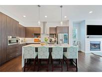 Modern kitchen featuring an island with seating, stainless steel appliances, and stylish pendant lighting at 1388 La France Ne St, Atlanta, GA 30307
