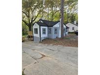 Charming remodeled home with a gray exterior, black trim, and well-kept front yard, offering curb appeal at 1427 Lorenzo Sw Dr, Atlanta, GA 30310
