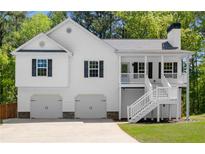 Charming home with a two-car garage and a inviting elevated front porch at 208 Julia Lynn Ln, Acworth, GA 30102